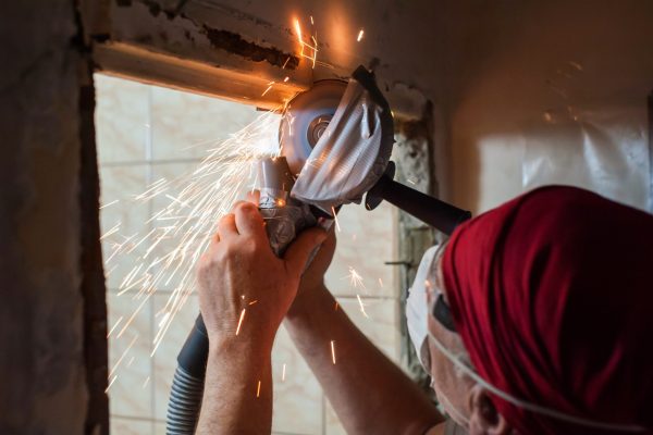 man-at-home-sawing-a-metal-door-frame-with-a-power-2025-01-09-15-28-31-utc